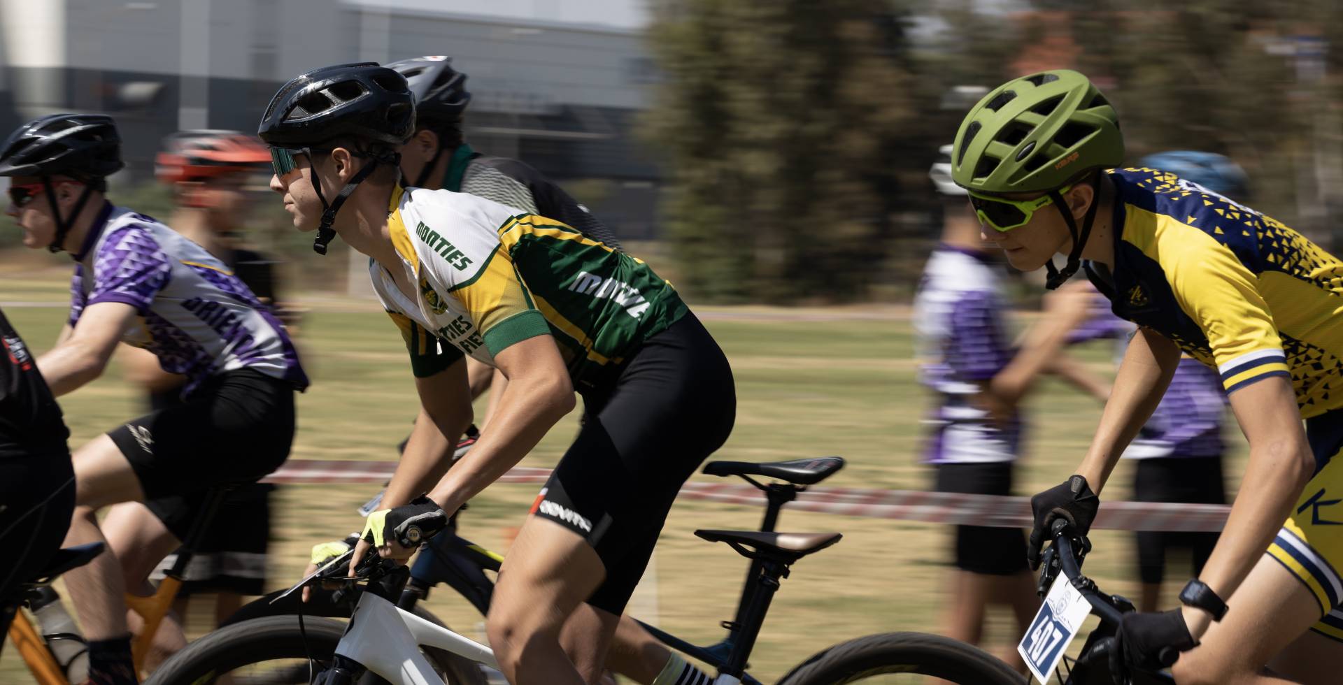 A pack of school riders racing