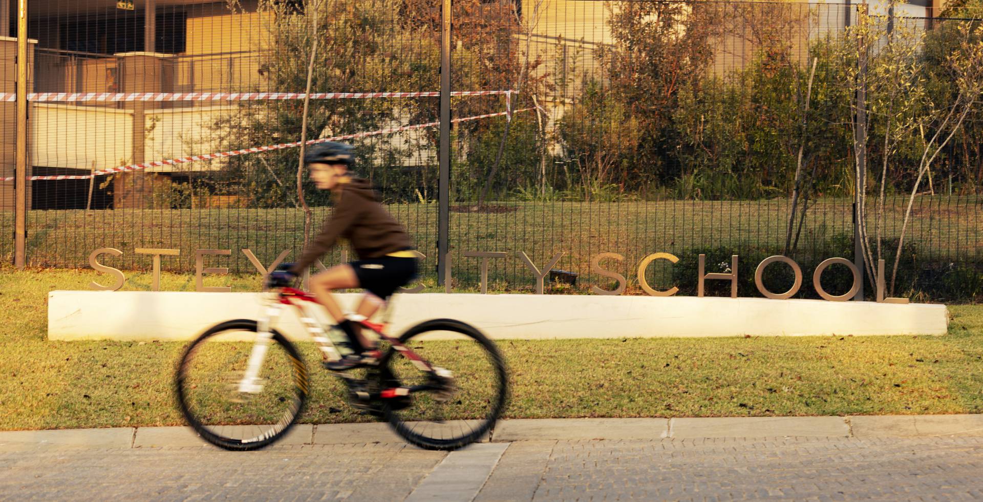 A rider passing the Steyn City School sign